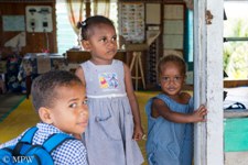 Fijian children at the doorwary to the school in the village
